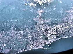 The area around Carrara, seen from an aircraft flying at 10,000 metres. The town is at the top of the picture, nearest to the marble quarries which are the white markings on the mountains.