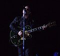 Bono plays guitar during "One" at a U2 360° Tour concert in Toronto.