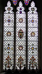 A 19th-century leadlight church window set with small stained glass roundels with symbolic motifs. England