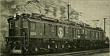 Two sequentially-numbered American boxcab locomotives coupled together at the head of a train. Each has its own diamond-shaped pantograph raised.