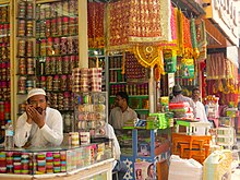 four men in traditional bridalwear shops in the market