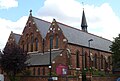 St Thomas's Church, Islington, London, 1888–89 by Ewan Christian, view of west front and south aisle showing Early English style lancets and narthex below the west windows[155]