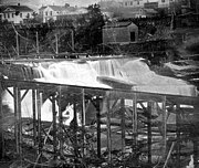 Waterfall surrounded by mills and scaffolding