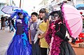 Kids getting picture taken with two dressed up at La Calavera Catrina