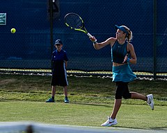 Katie Swan baring her midriff and outie belly button during a tennis match