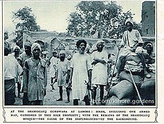 Photograph of the dispute and demolition of the Shaheed Ganj Mosque in Lahore - Sikhs gathered at the site, including one who is armed with a weapon.jpg