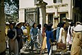 Hanoi students on a lunch break leave school with briefcases and bicycles in 1952