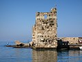 Ruined tower at entrance to port