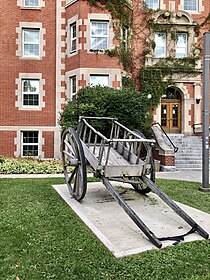 Full size Red River cart replica in front of Pembina Hall