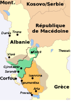 L'Épire, une région à cheval sur la Grèce et l'Albanie. Sur cette carte on peut voir l'extension approximative de l'Épire antique (en gris), de l'actuelle préfecture grecque d'Épire (en orange), de la partie habitée majoritairement par des « Grecs albanais » (en vert) et les limites de l'« Épire du Nord » en pointillés. Gjirokastre (Argyrokastro) et Korçë (Koritsa) sont les deux principales villes de l'Épire du Nord.
