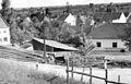 Pohled ze stráně na Krajčův mlýn před zahájením rekonstrukce, klády k pořezání, bez data (začátek 40. let 20. století)
