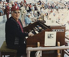 Snapp sitting at his organ in Jack Russell Stadium