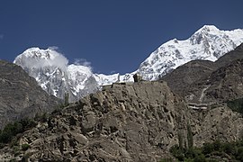 A view of the Altit Fort taken from the Karakoram Highway, Pakistan. In the background, snow-covered Hunza peak is seen.