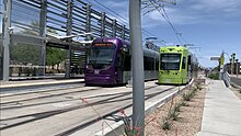 A Valley Metro Rail train and Tempe Streetcar tram are stopped next to each other at the Dorsey/Apache Blvd station