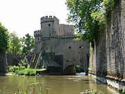 A city gate with its towers, the defensive walls, and the city ditch from the 13th century in Metz, France