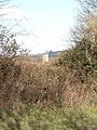 The Church Tower of Avebury see through a hedge