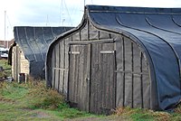 Upturned boats in the harbour of Lindisfarne used as sheds