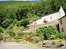 Espace fleuri aménagé par la commune avec un abreuvoir