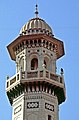 The minarets of the mosque feature cupolas and overhanging eaves