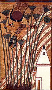 Painting of a cow whose head protrudes from a hill, in front of which stand papyrus stalks and a pyramidal chapel