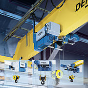 Overhead crane and hoist mounted on a trolley that can be moved across the bridge beam