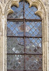 Medieval diamond pane and armorial glass at Ightham Mote, England, seen from the exterior