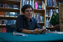 Aitken signing copies of Eighth Habitation at Gleebooks, 2009