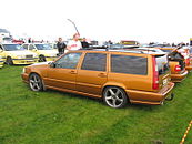 Rear drivers side view of a saffron coloured V70 R