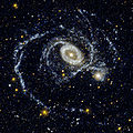 NGC 1512 (links) zusammen mit NGC 1510 (rechts) aufgenommen im Ultravioletten von GALEX: Deutlich erkennbar die Störung der Spiralstruktur, hervorgerufen durch die gravitative Wechselwirkung der Galaxien.
