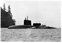 Grounded submarine Sam Houston with a nearby tug