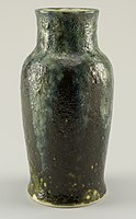 DP vase, c. 1896–1908, gray-white thrown stoneware body, olive green volcanic glaze pitted with yellow-green "craters." A blue-gray and green glaze flowing over the base glaze extending from rim to shoulder, also pitted