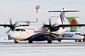 NordStar, snow, in front of a UTair ATR 72