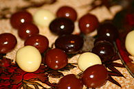 A mix of white, milk, and dark chocolate-covered coffee beans