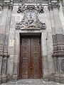 Antique, hand carved wooden door to a Church in the Historic Center of Quito near the Presidential Palace.