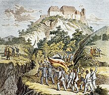 En arrière-fond se trouve le château de Wartbourg. Au premier plan un cortège portant un grand drapeau allemand s'y dirige.