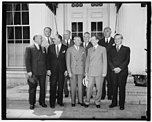 front row, left to right: Barney Balaban, Paramount; Harry Cohn, Columbia Pictures; Nicholas M. Schenck, Lowe's; Will H. Hays, and Leo Spitz, RKO. artists; Sidney Kent, 20th Century Fox; N.J. Blumberg, Universal; and Albert Warner, Warner Bros. in 1938