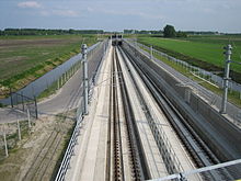 Ballastless double track of the type "Rheda 2000" including concrecte slabs and ties/sleepers, rails, and drainage slits.