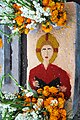 Gravesite decorated with image of unknown saint done in colored sawdust