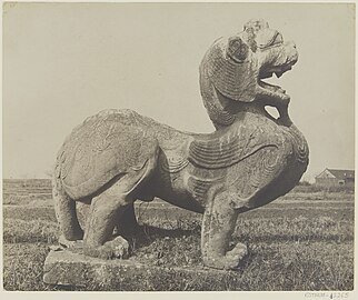 A Chinese Pixiu, (Chinese: 貔貅; pinyin: píxiū; Wade–Giles: P'i-hsiu) head of a Chinese dragon, body of a lion and with a pair of feathered wings, at the tomb of Emperor Wu of Southern Qi (Xiao Ze) in Danyang (near Nanjing, China).