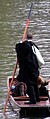 Punting along the Cam in academic dress after a graduation ceremony.