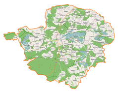 Mapa konturowa powiatu milickiego, w centrum znajduje się punkt z opisem „Milicz”