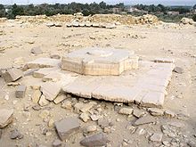 Huge limestone blocks on the ground, in the shape of Egyptian hieroglyphs.