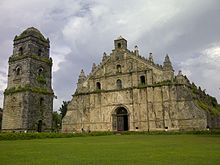 Old, mossy church with a lawn in front