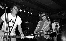 A black-and-white photo of the band playing onstage