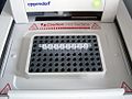 Opened Eppendorf thermal cycler with a PCR strip