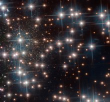 Galaxy nicknamed Bedin I is located behind the bright stars of the cluster.[10]