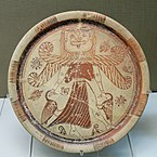 Fig. 3. Winged Gorgon with, volute nose, wide mouth, tusks/fangs, tongue, and beard, as Mistress of Animals flanked by geese; plate from Kameiros, Rhodes, British Museum A 748 (late seventh century BC)[69]