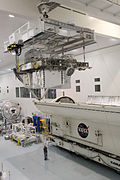 One of two overhead cranes hoisting a space shuttle payload in the Space Station Processing Facility