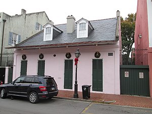 Side gabled roof with narrow gabled dormer windows and an abat-vent roof extension[2]