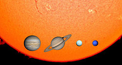 Four of the planets in front of the sun: Jupiter, Saturn, Uranus, and Neptune[6]